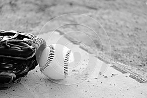 Baseball glove with ball on sports field closeup