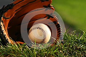 Baseball and glove on the grass after the big game