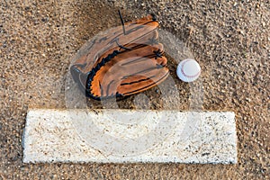 Baseball and glove on pitcher`s mound flat lay