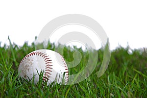 A baseball in the grass photo