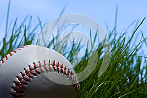 Baseball, grass and blue sky