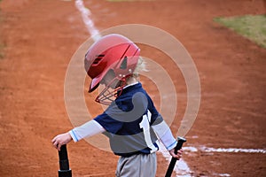 Baseball kid up at bat wearing a helmet
