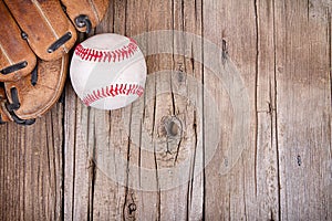 Baseball and mitt on wooden background