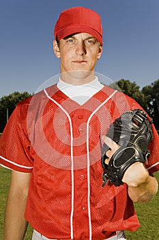 Baseball pitcher holding glove