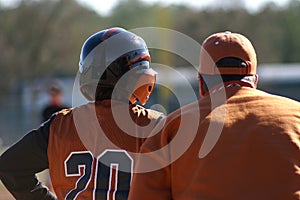 Baseball player and base coach photo