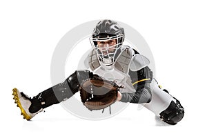Baseball player, catcher in action in white sports uniform and equipment practicing isolated on a white studio