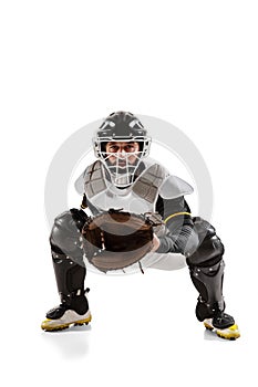Baseball player, catcher in white sports uniform and equipment practicing isolated on a white studio background.