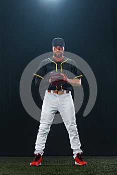 Baseball player on dark background. Ballplayer portrait.