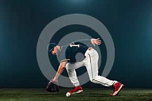 Baseball player on dark background. Ballplayer portrait.