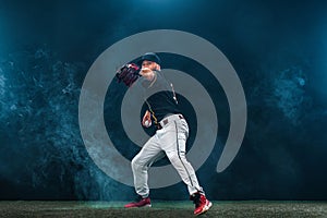 Baseball player on dark background. Ballplayer portrait.