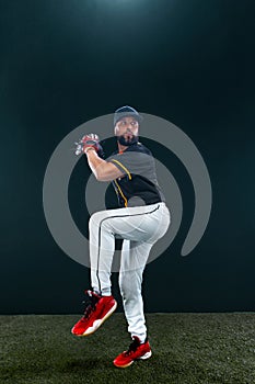 Baseball player on dark background. Ballplayer portrait. photo