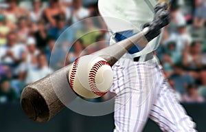 Baseball player hitting ball with bat in close up