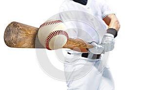 Baseball player hitting ball with wooden bat