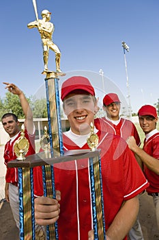 Baseball Player Holding Trophy