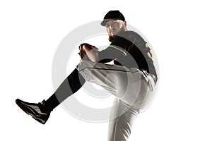 Baseball player, pitcher in a black uniform practicing on a white background.