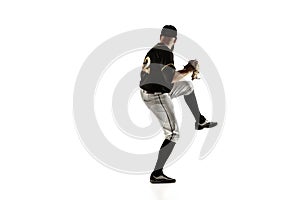 Baseball player, pitcher in a black uniform practicing on a white background.