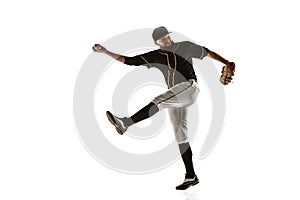 Baseball player, pitcher in a black uniform practicing on a white background.