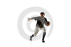 Baseball player, pitcher in a black uniform practicing on a white background.