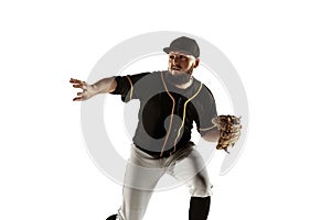 Baseball player, pitcher in a black uniform practicing on a white background.