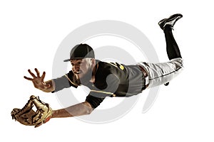 Baseball player, pitcher in a black uniform practicing on a white background.