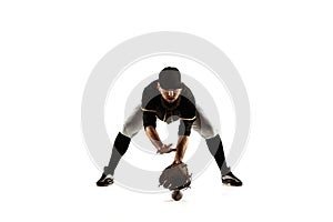 Baseball player, pitcher in a black uniform practicing on a white background.