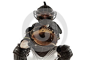 Baseball player, pitcher in a black uniform practicing on a white background.