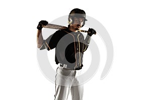 Baseball player, pitcher in a black uniform practicing on a white background.