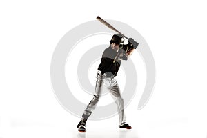 Baseball player, pitcher in a black uniform practicing on a white background.