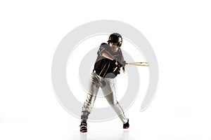Baseball player, pitcher in a black uniform practicing on a white background.