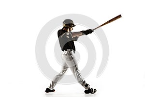 Baseball player, pitcher in a black uniform practicing on a white background.