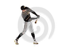 Baseball player, pitcher in a black white sports uniform practicing isolated on a white studio background.