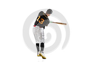 Baseball player, pitcher in a black white sports uniform practicing isolated on a white studio background. Back view
