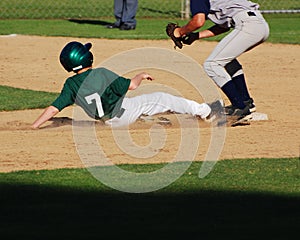 Baseball player sliding into 2nd base.
