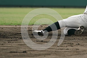 Baseball player sliding into a base