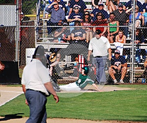 Baseball player sliding into Home