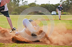 Baseball player sliding into third base