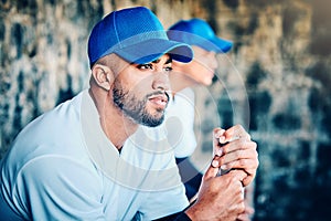 Baseball player, stadium dugout and sport training focus of a athlete looking at game. Summer sports, teamwork and