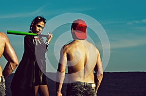 Baseball players of muscular men with body and wet torso in cap, girl with long fashionable indie hairstyle, woman