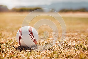Baseball, sports ball and empty sport field on grass outdoor training pitch. White ball on the ground for exercise