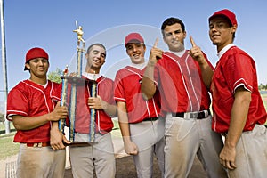 Baseball team-mates holding trophy