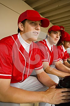 Baseball Team Mates Sitting In Dugout