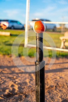 Baseball on top of a tee ball stand ready to be hit