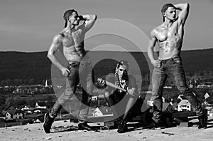 Baseball woman and muscular men in cap