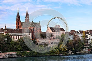 Basel Munster church in the river Rhine with the big ferris wheel photo