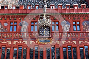Basel switzerland, april 25. 2021: red city hall, front view with clock and swiss cantonal coat of arms, the building is photo