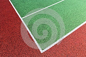Baseline on green tennis court