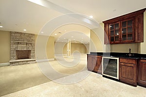 Basement with bar and fireplace