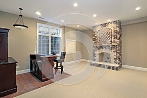 Basement with brick fireplace