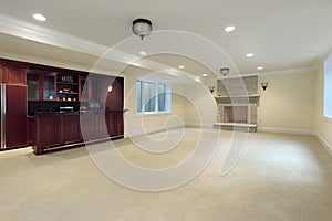 Basement with fireplace and bar