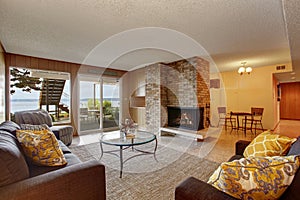 Basement living room with fireplace and walkout patio photo